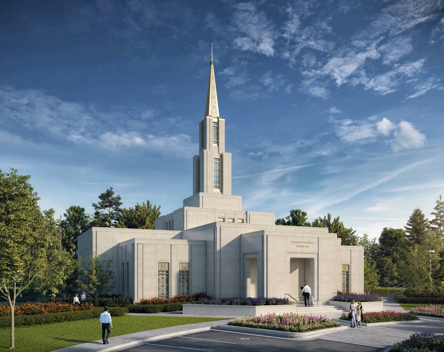 Modern temple with a tall spire, surrounded by landscaped gardens